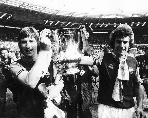 Trevor Brooking right and Kevin Locke hold the FA Cup Mafter beating Fulham in the FA