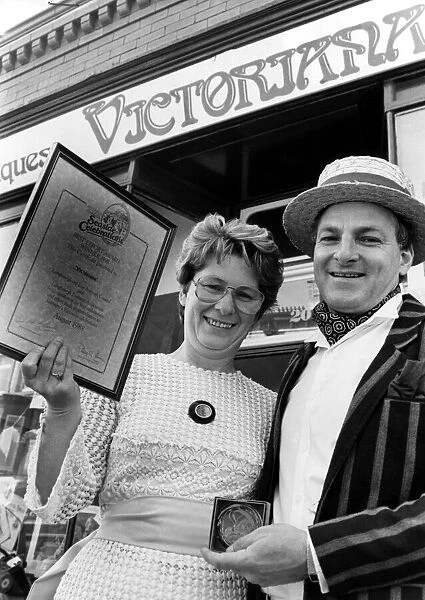 Trevor and Joan Taylor pose with their award for their window display at their shop