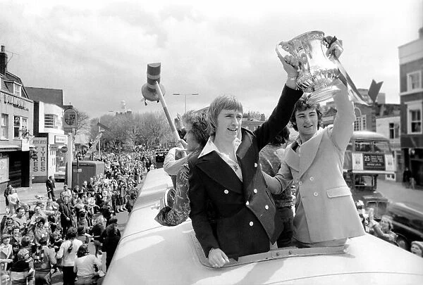 Triumphant West Ham players parade the FA cup trophy to their fans from an open top
