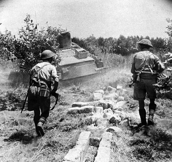 Troops following up a tank in Sicily, Italy. August 1943
