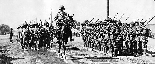 Troops from a Lancashire Regiment led by their commanding officer on horseback pass an