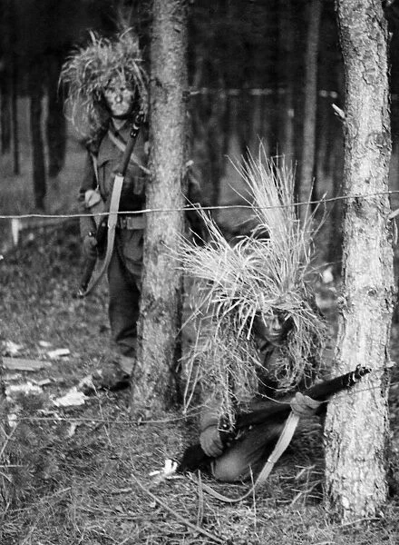 Troops wearing their war paint with grass and straw for their headgear