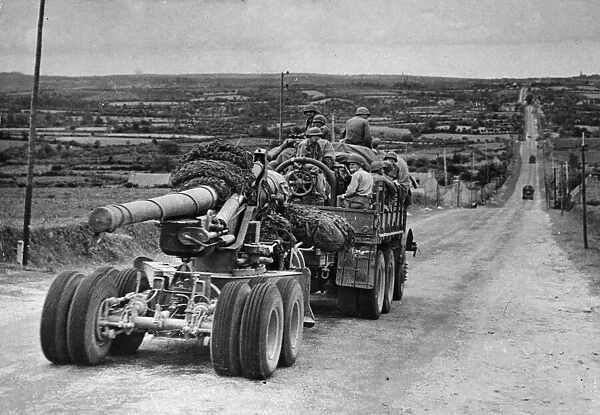 A truck carrying members of an Artillery unit roars over the highways of France