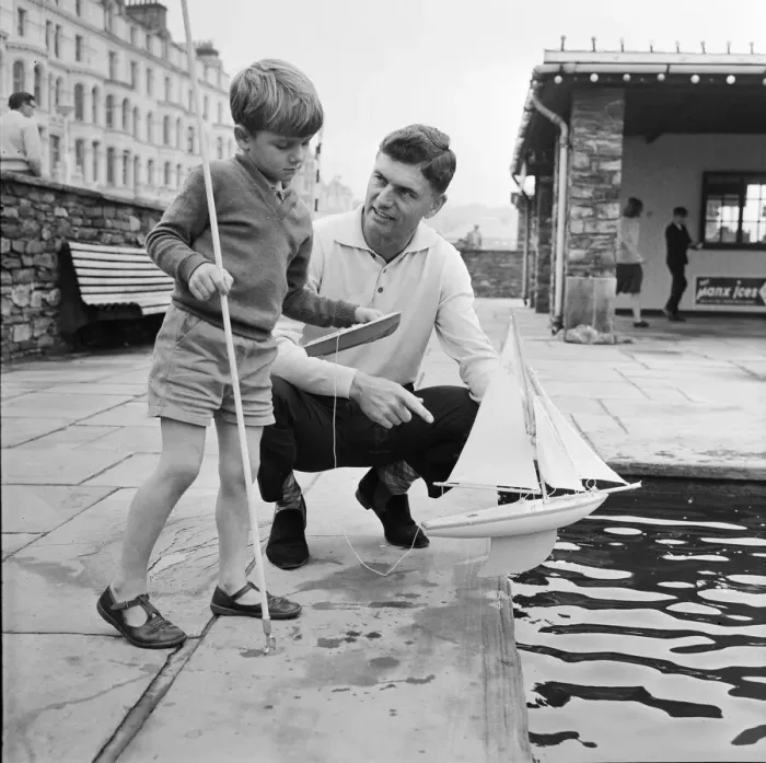 Framed Print : TT Rider Jim Redman with his son at the Douglas Promenade boating pool Framed Print : TT Rider Jim Redman with his son at the Douglas Promenade boating pool