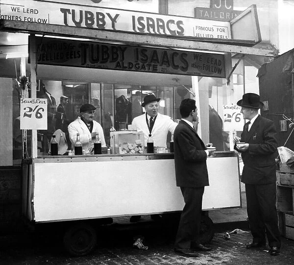 Tubby Isaacs behind the counter of one of his mobile stalls selling jellied eels while