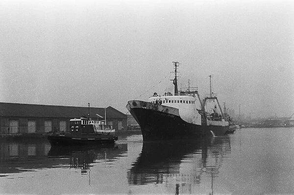 The tug Castle guides the stern trawler Boston Lincoln into a misty St Andrews Dock