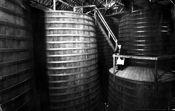 The Tun Room containing oak vats with Brewery Foreman Dan Rodway, 1930 s