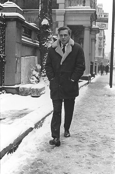 TV Presenter David Attenborough - March 1965 - walking to work on a snowy morning the day