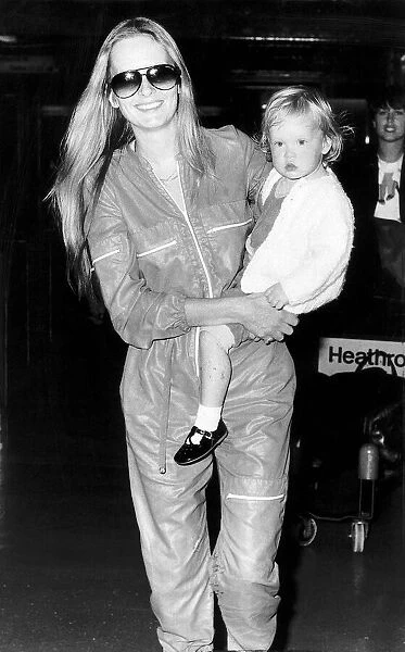 Twiggy actress and model with 21 month old daughter at Heathrow airport. July 1980