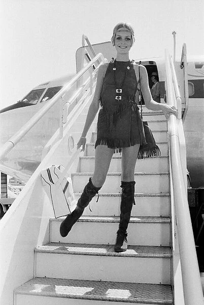 Twiggy, (real name Leslie Hornby) English model, seen in a Hippie gear outfit leaving