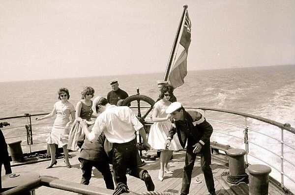 Twisters on the after-deck dancing with the wake of the Royal Daffodil in the background