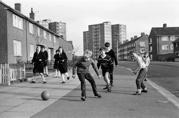Framed Print : A typical street in Kirkby, Liverpool. Boys playing football in the street Framed Print : A typical street in Kirkby, Liverpool. Boys playing football in the street