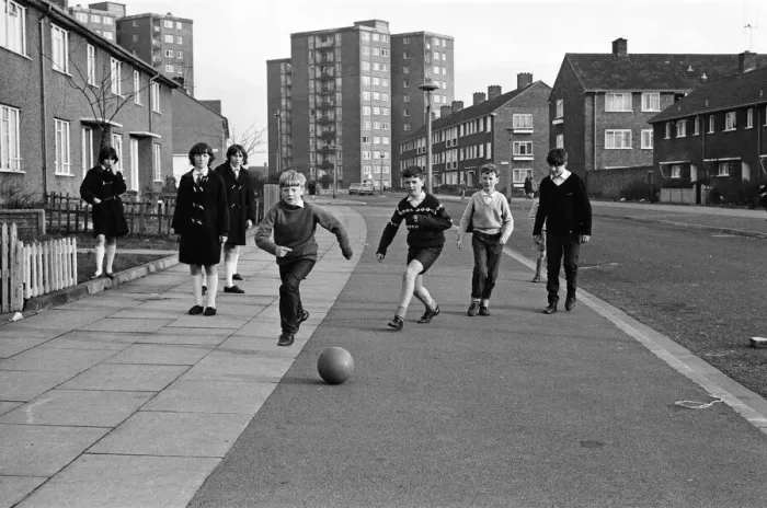 Framed Print : A typical street in Kirkby, Liverpool. Boys playing football in the street Framed Print : A typical street in Kirkby, Liverpool. Boys playing football in the street