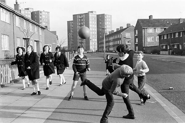 A typical street in Kirkby, Liverpool. Boys playing football in the street