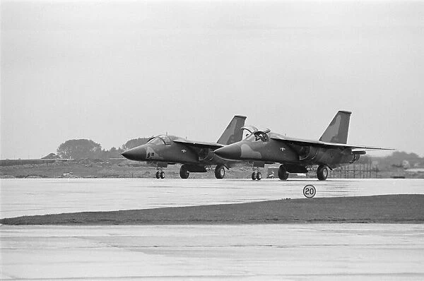 Two U. S. A. F F111 aircraft fly into U. S. A. F, Heyford. Colonel G
