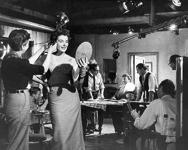 An un-named actress has her make-up touched up between filming at Ealing Studios