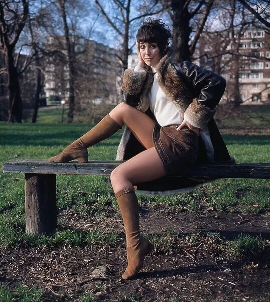 Una Stubbs actress sitting on a bench hand at face