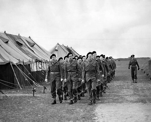 Back in uniform, and back in line. A squad of newly uniformed Z men march past a line of