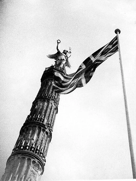 Union Jack flag flying beside the German victory column from the war of 1870