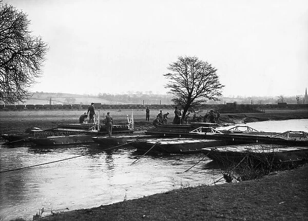 A unit of Royal Engineers practicing pontoon bridge building over a river in Derbyshire