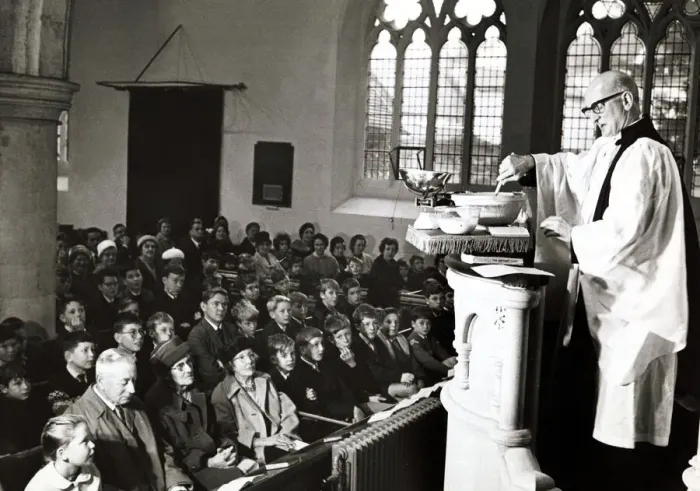 Framed Print : Unusual - A vicar prepares his christmas pudding at a service in church