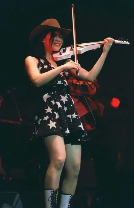 Framed Print : Vanessa Mae on stage playing white violin wearing mini skirt