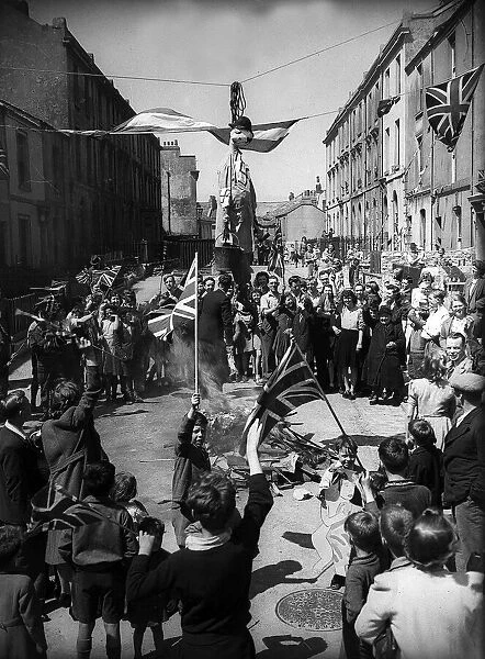 VE Day celebrations on streets of London where german figure is burnt after announcement