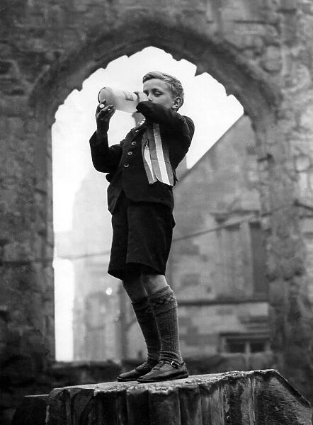 After the VE Day service in the cathedral ruins a youngster bedecked with a rosette