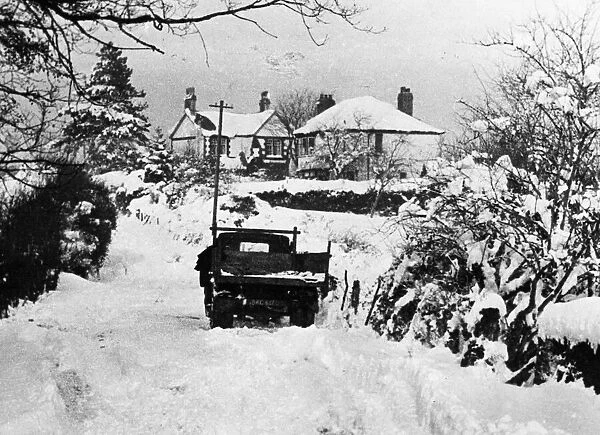 A vehicle making its way through thick snow in rural Llanedeyrn