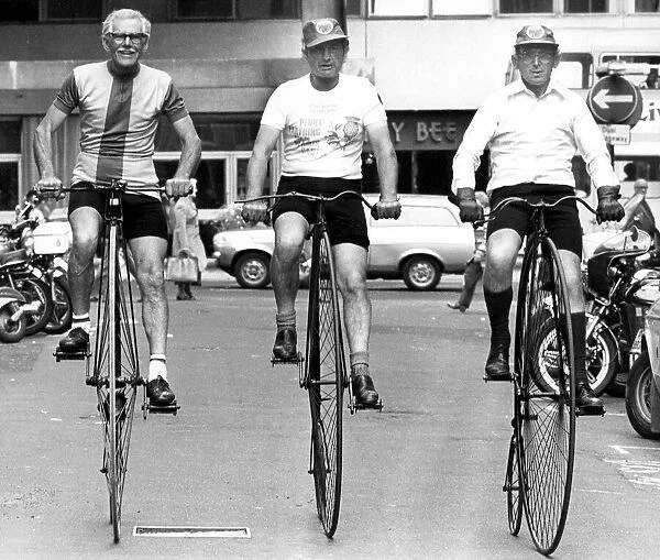 Three veteran cyclists riding high on their penny-farthings in Newcastle