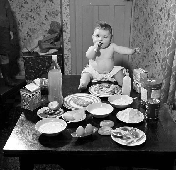Victor Reay 2 1  /  2 stone 7 month old baby sitting on table with the food that