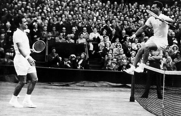 Victor Seixas leaps over net after win against Kurt Nielson in the 1953 Wimbledon mens
