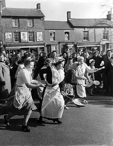 A view of a village pancake race in action. February 1951 P005030