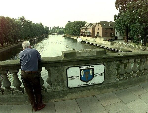 A view from the Workman Bridge in Evesham. Man standing on a bridge over the River Avon