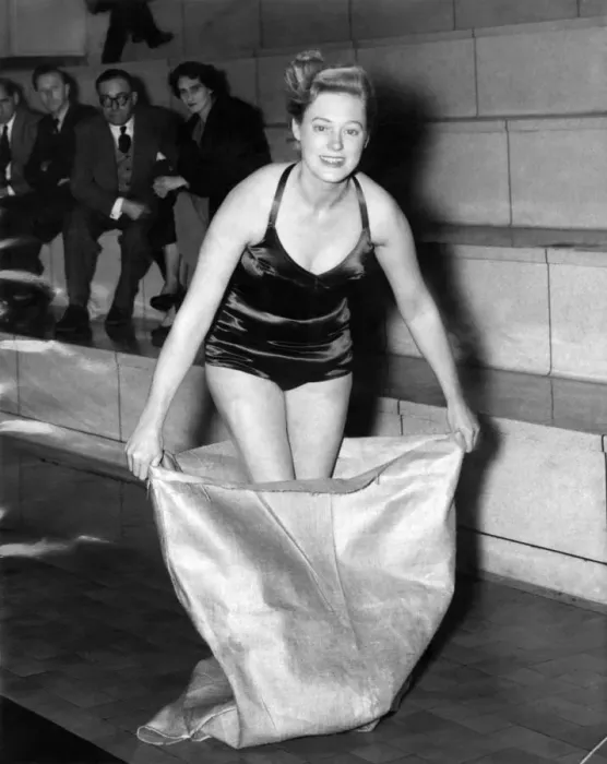Framed Print : Views - Swimsuits, unsinkable. Woman wearing halterneck swimming costume steps into a Framed Print : Views - Swimsuits, unsinkable. Woman wearing halterneck swimming costume steps into a