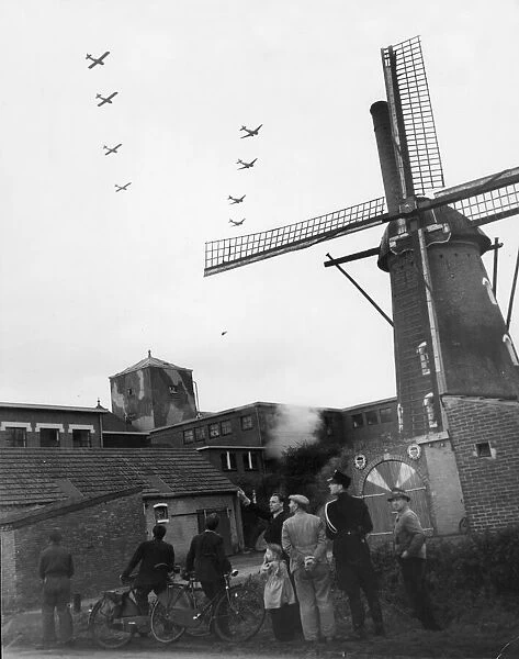 Villagers of Valkenswaard, south of Eindhoven, Holland, watch Allied aircraft