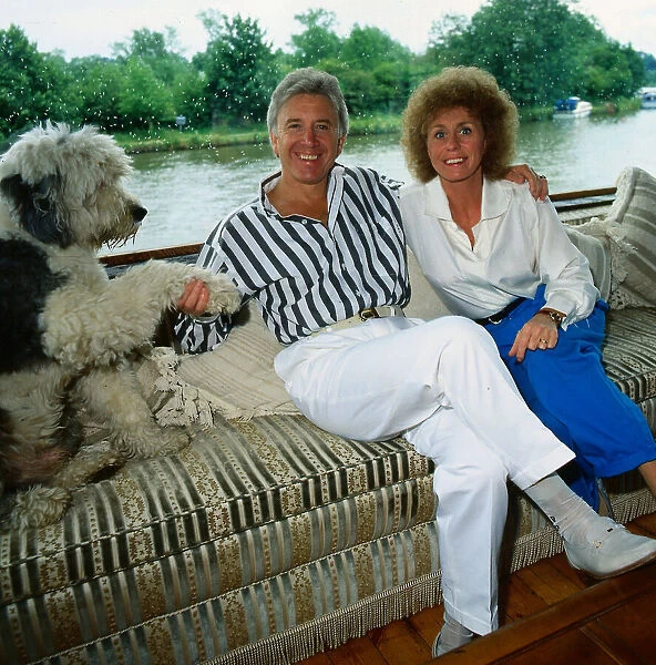 Vince Hill singer July 1988 Sitting wearing striped shirt with wife Anne and dog