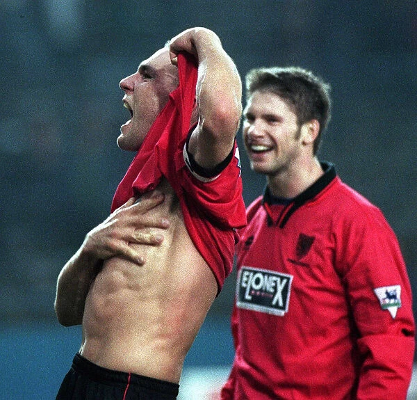 Vinnie Jones celebrates by lifting his shirt and putting his hand across his chest after