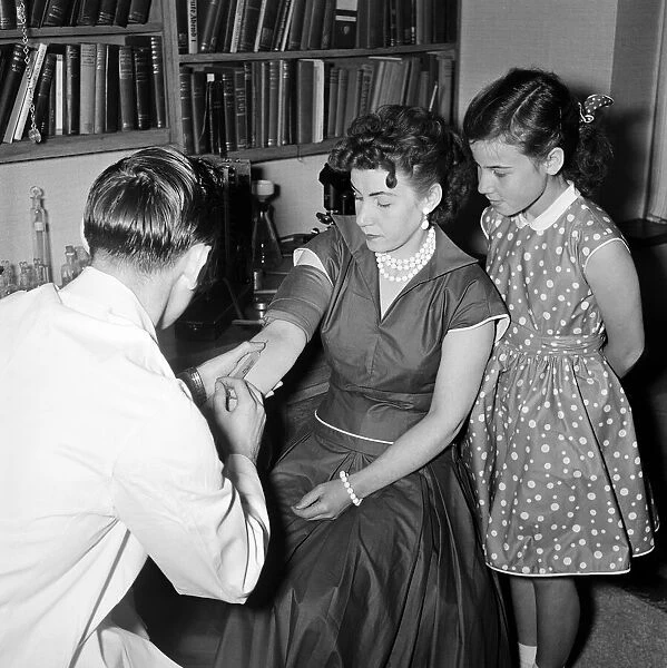 Virgin mother Emmimarie Jones and her daughter Monica undergo medical tests. June 1956