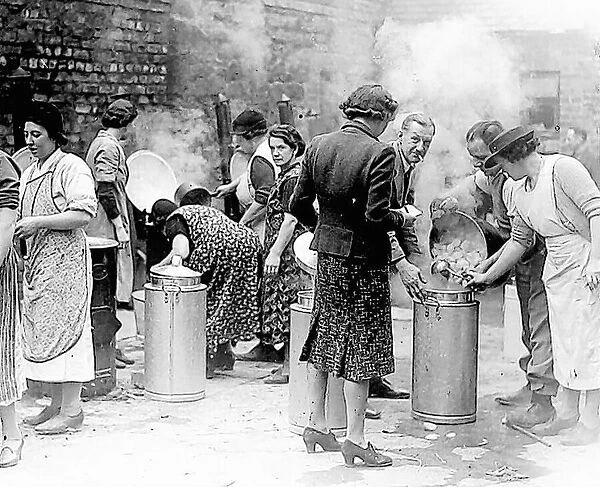 Volunteers prepare a meal for families made homeless by bombing in October, 1941