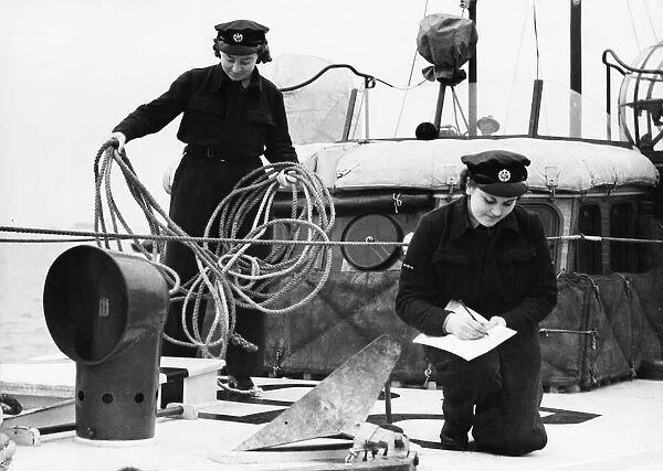 W. A. A. F airwomen on an R. A. F. station checking the equipment on a new boat