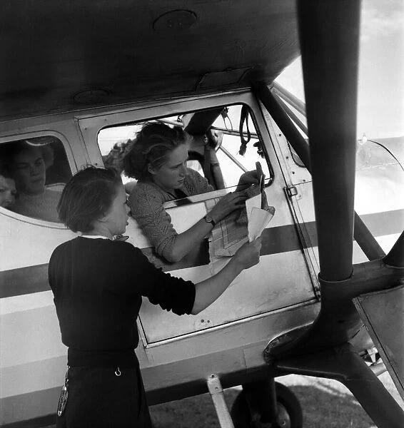 W. J. A. C. girls seen here planning a route to her destination. August 1952 C4029