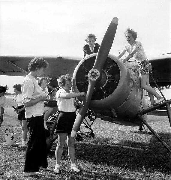 W. J. A. C. girls seen here servicing plane. August 1952 C4029