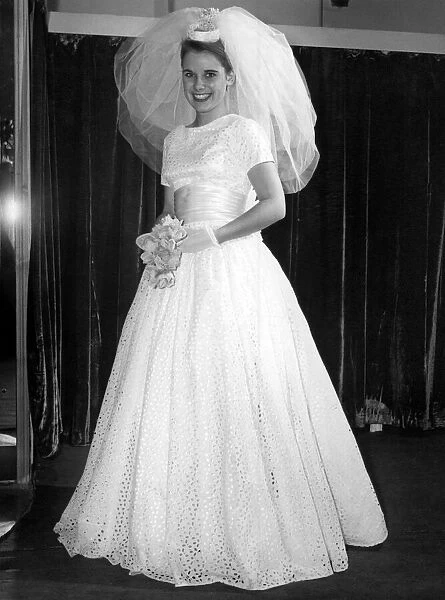 She walks to the altar a demure vision in full-length gown. October 1960 P007843