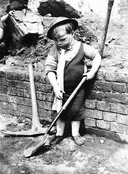 War 1939-45 Little boy playing on a Bomb site