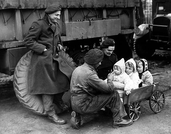 War: Invasion of France February 1945 British troops with German children
