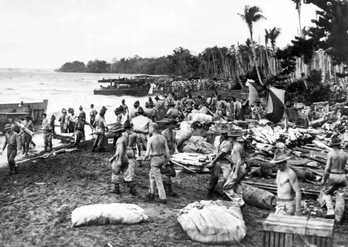 Framed Print : War in the Pacific. Allied soldiers unload supplies and equipment onto the beach of a