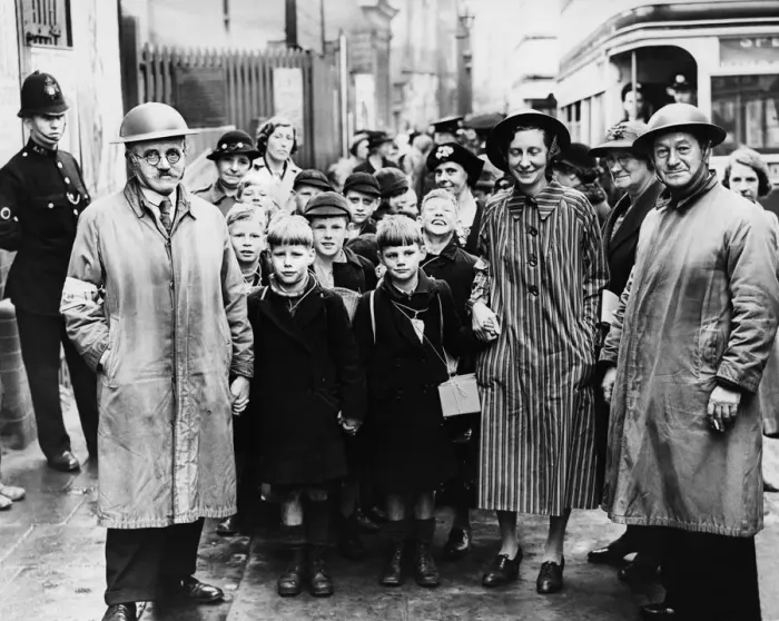 Framed Print : Wardens with tin hats hold children hands as they walk from Moor Street Station in an Framed Print : Wardens with tin hats hold children hands as they walk from Moor Street Station in an