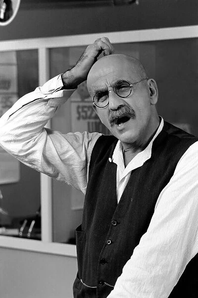 Warren Mitchell scratches his head trying to decide which team he wants to win the cup