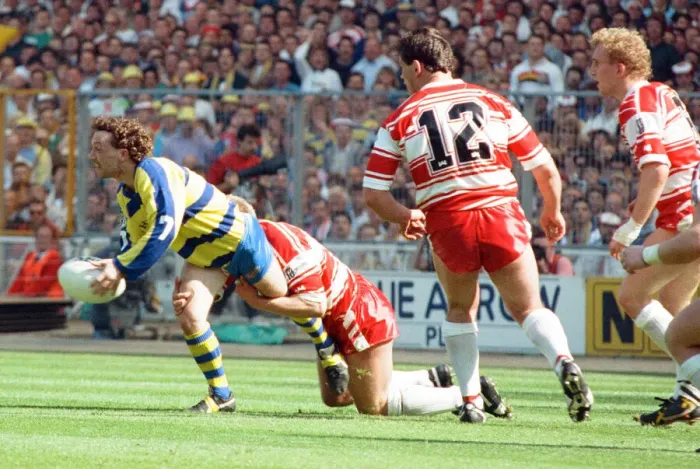 Framed Print : Warringtons Paul Bishop gets the ball away just as the Wigan defence close him down